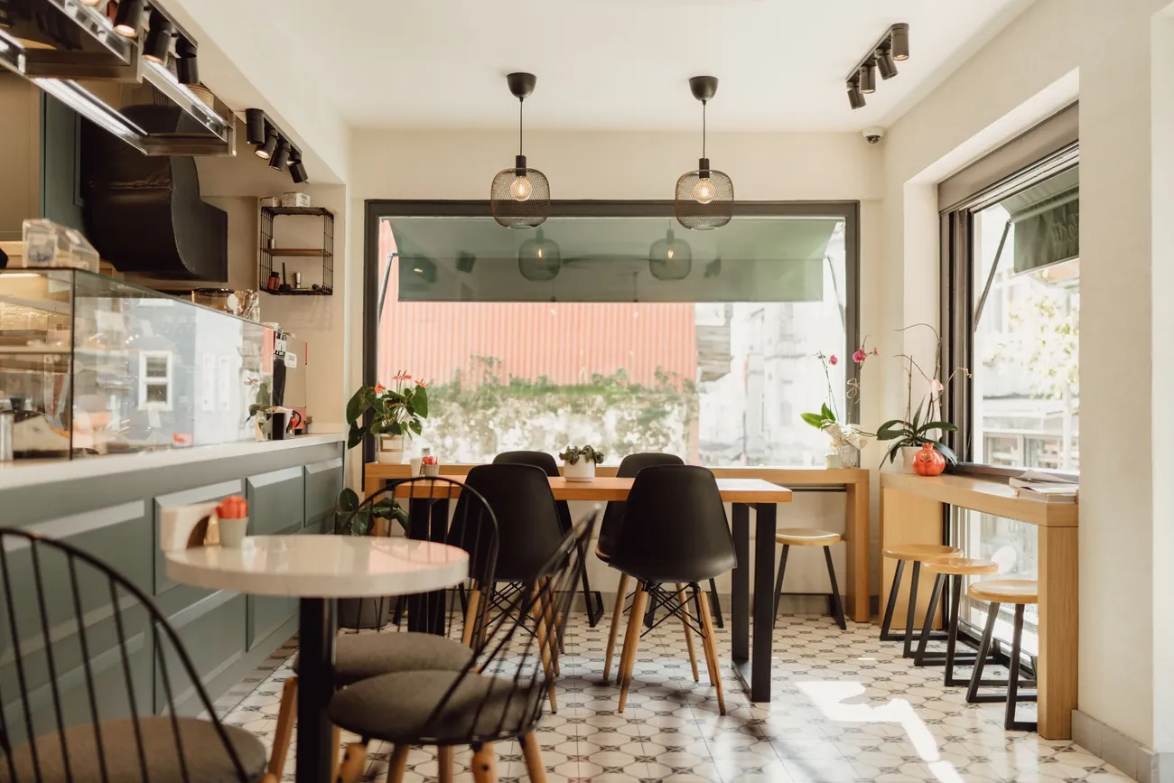 Café dining area with seating, a service counter and a tiled floor