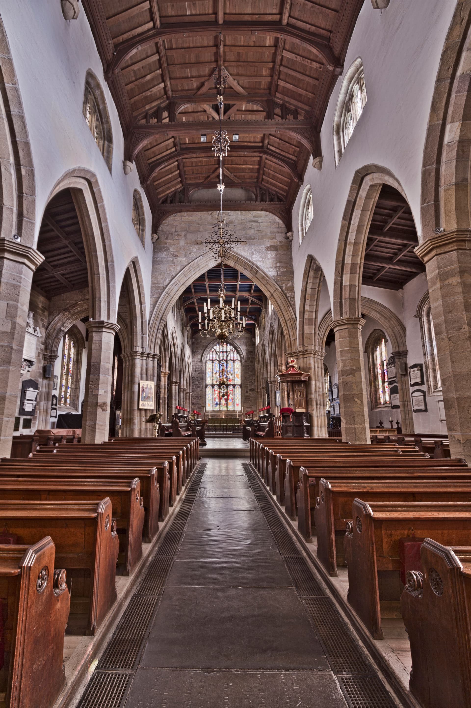 Interior of a church sanctuary with wooden pews and a central aisle