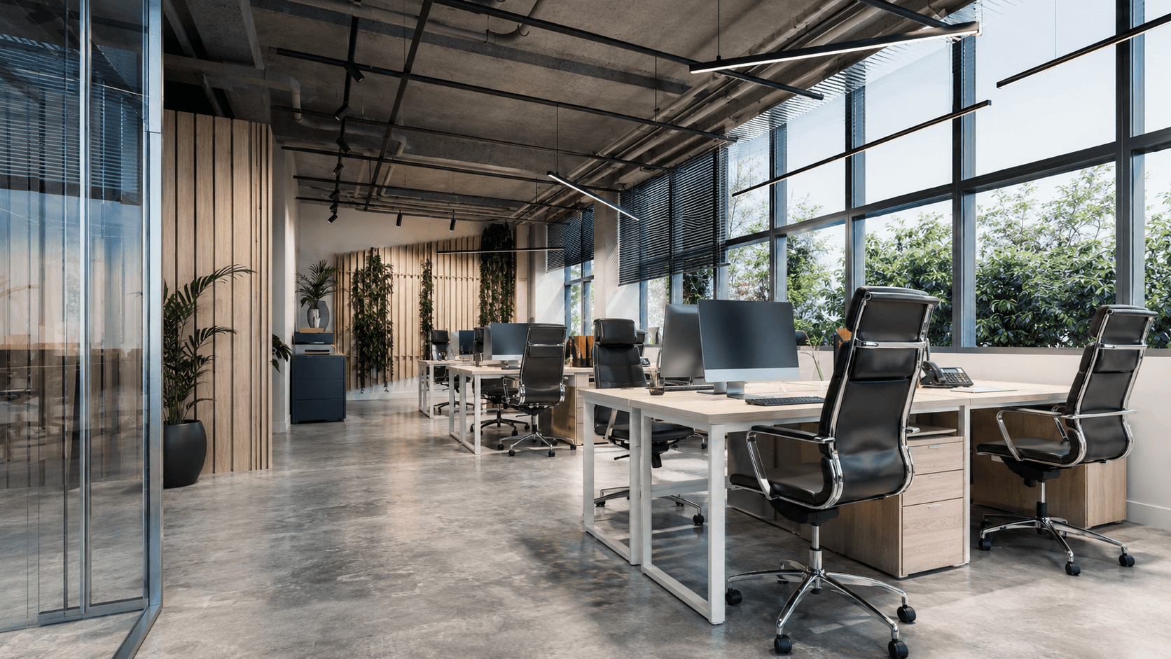 Bright, open-plan office with workstations, glass partitions, and large windows